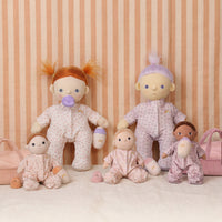 Set of baby dolls in pajamas with a striped background