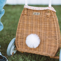 Woven rattan basket on wheels with printed lining. Perfectly sized for your kid to transport their favourite toys, dolls and treasures on their adventures. 
