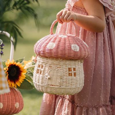 Olli Ella Rattan Mushroom Basket - pink musk and white coloured held by girl