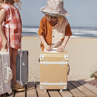 The ultimate kids travel suitcase. Yellow suitcase for kids holidays, with straps to carry their favourite doll / toy.