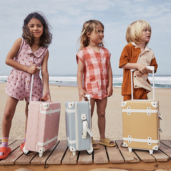 The ultimate kids travel suitcase. Blue suitcase for kids holidays, with straps to carry their favourite doll / toy.