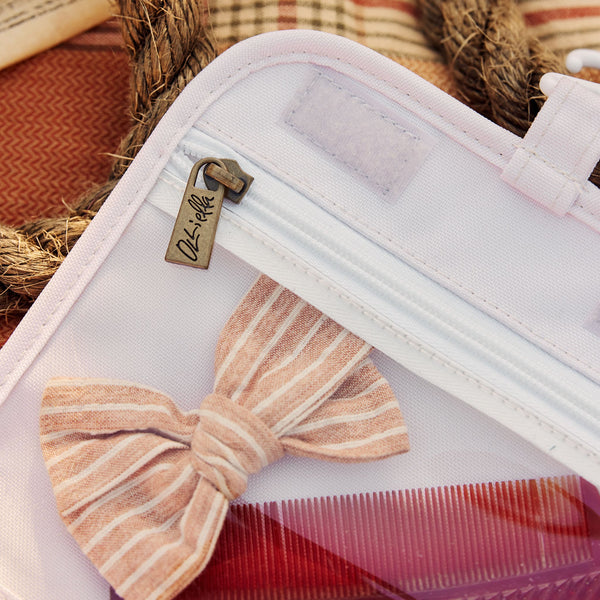Compact, durable kids flower printed toiletry bag by Olli Ella. Perfect for toiletries and travel essentials. Ideal for organized packing, made from eco-friendly materials.